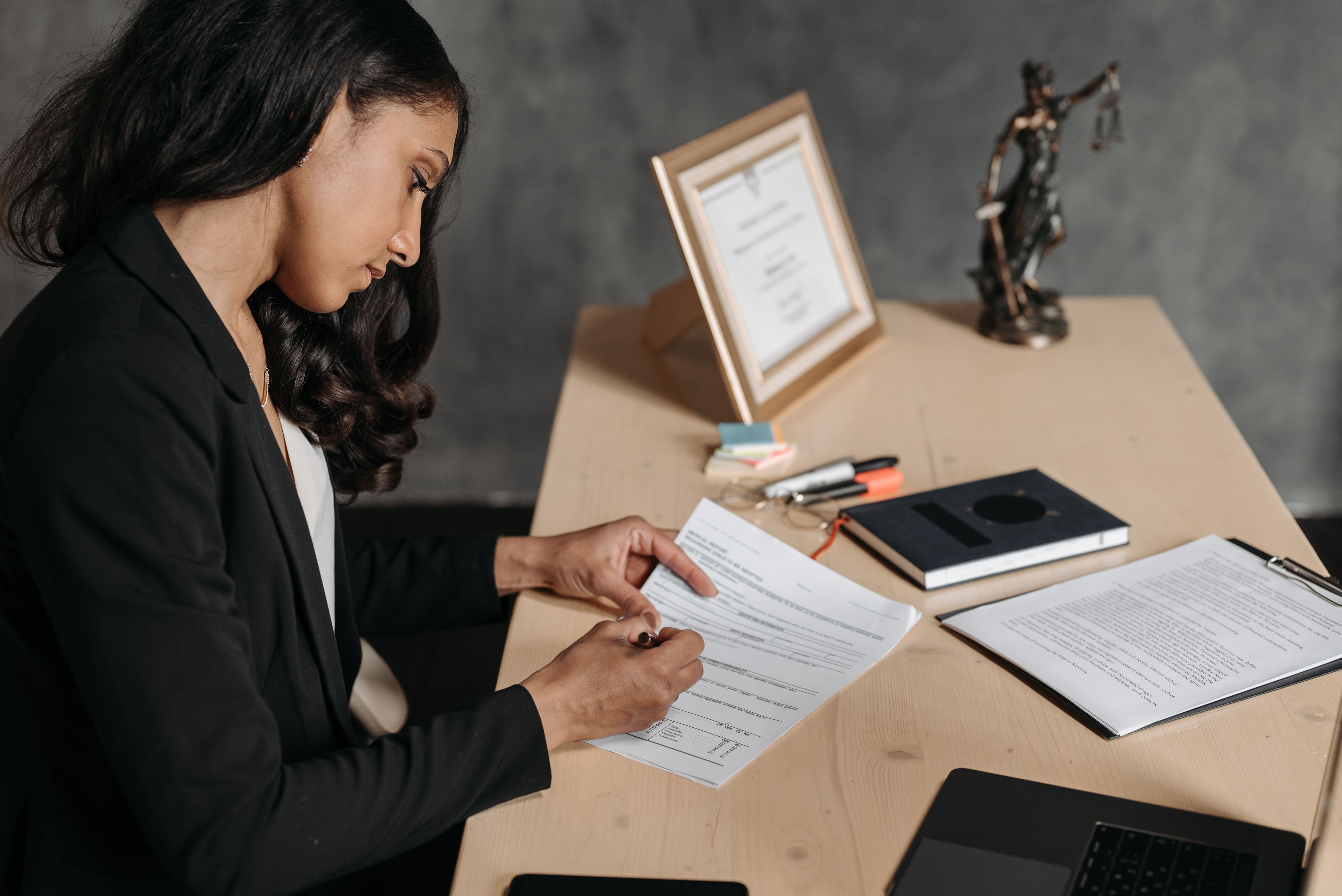 Lawyer reviewing paperwork and case documents in an office setting