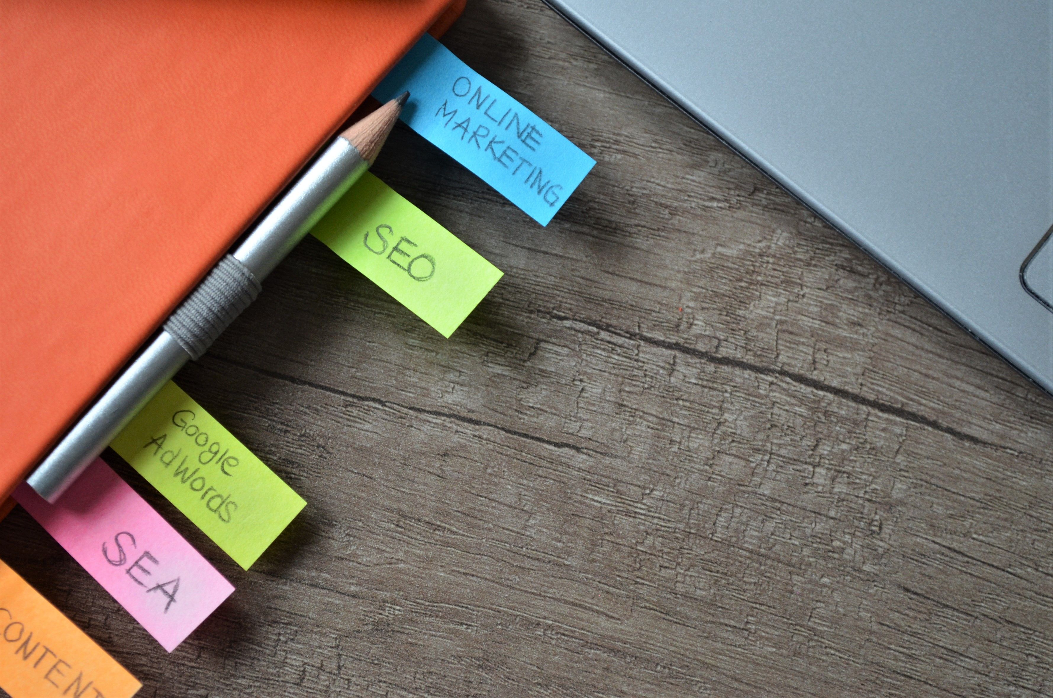 SEO strategy planner notebook with colorful sticky notes and pencil for planning keyword research