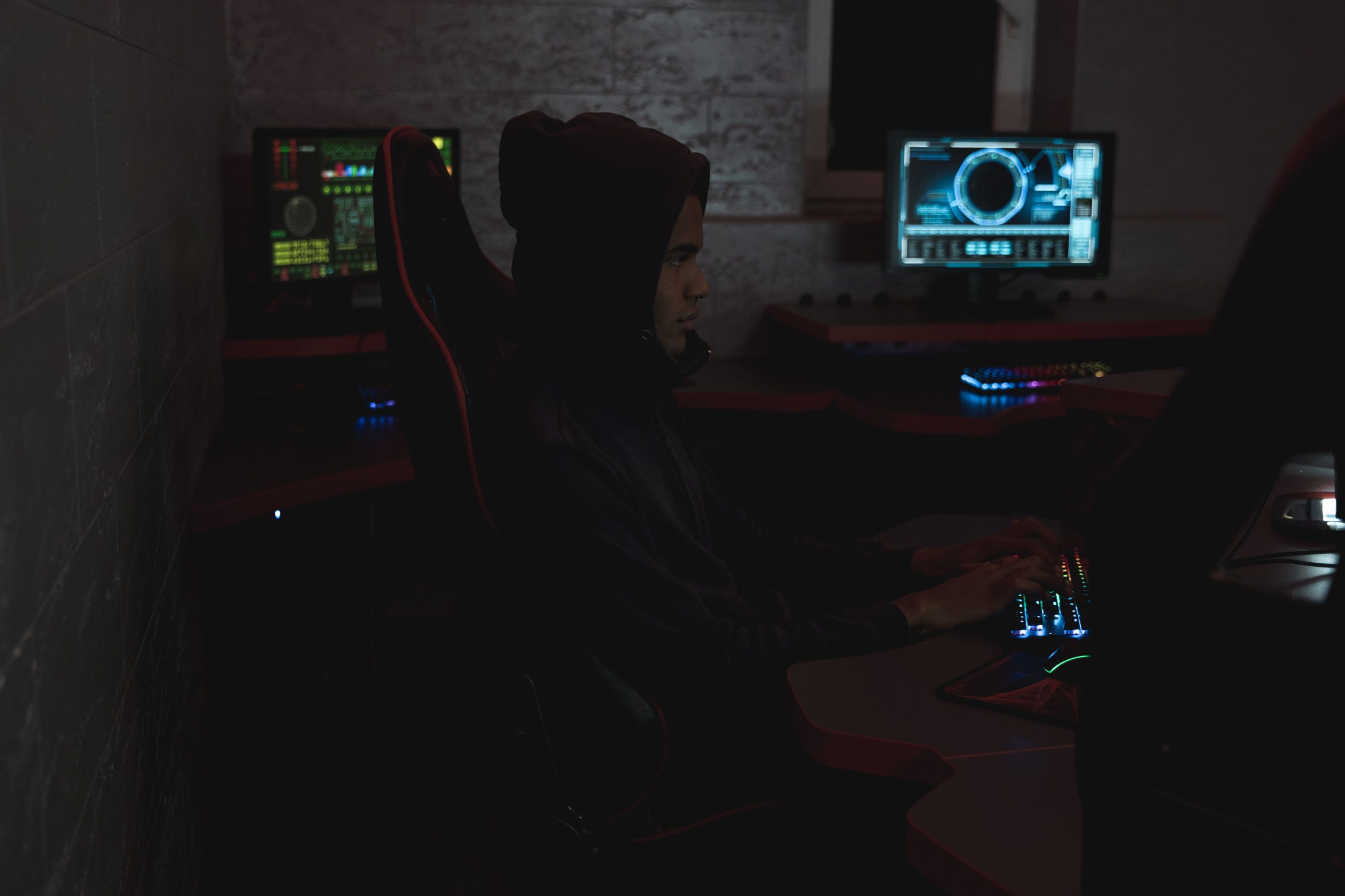Cybersecurity analyst reviewing data across multiple monitors during an investigation.